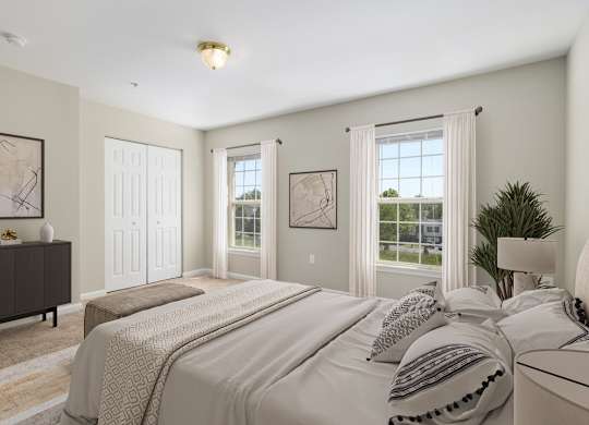 A bedroom with a large bed and a dresser.